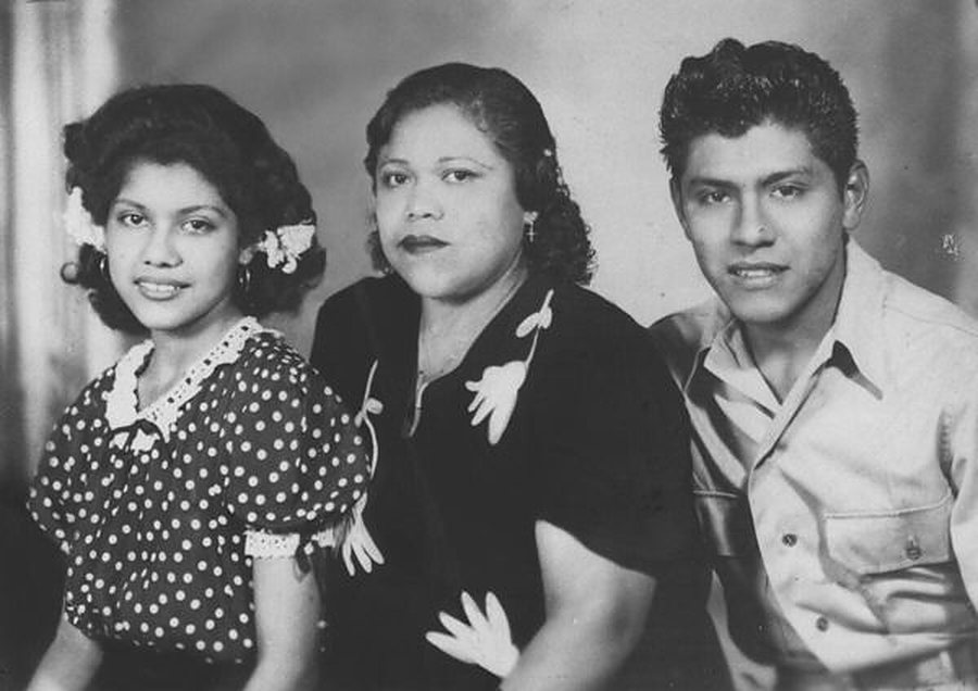 A black-and-white portrait of a mother with her daughter and son, from the 1940s